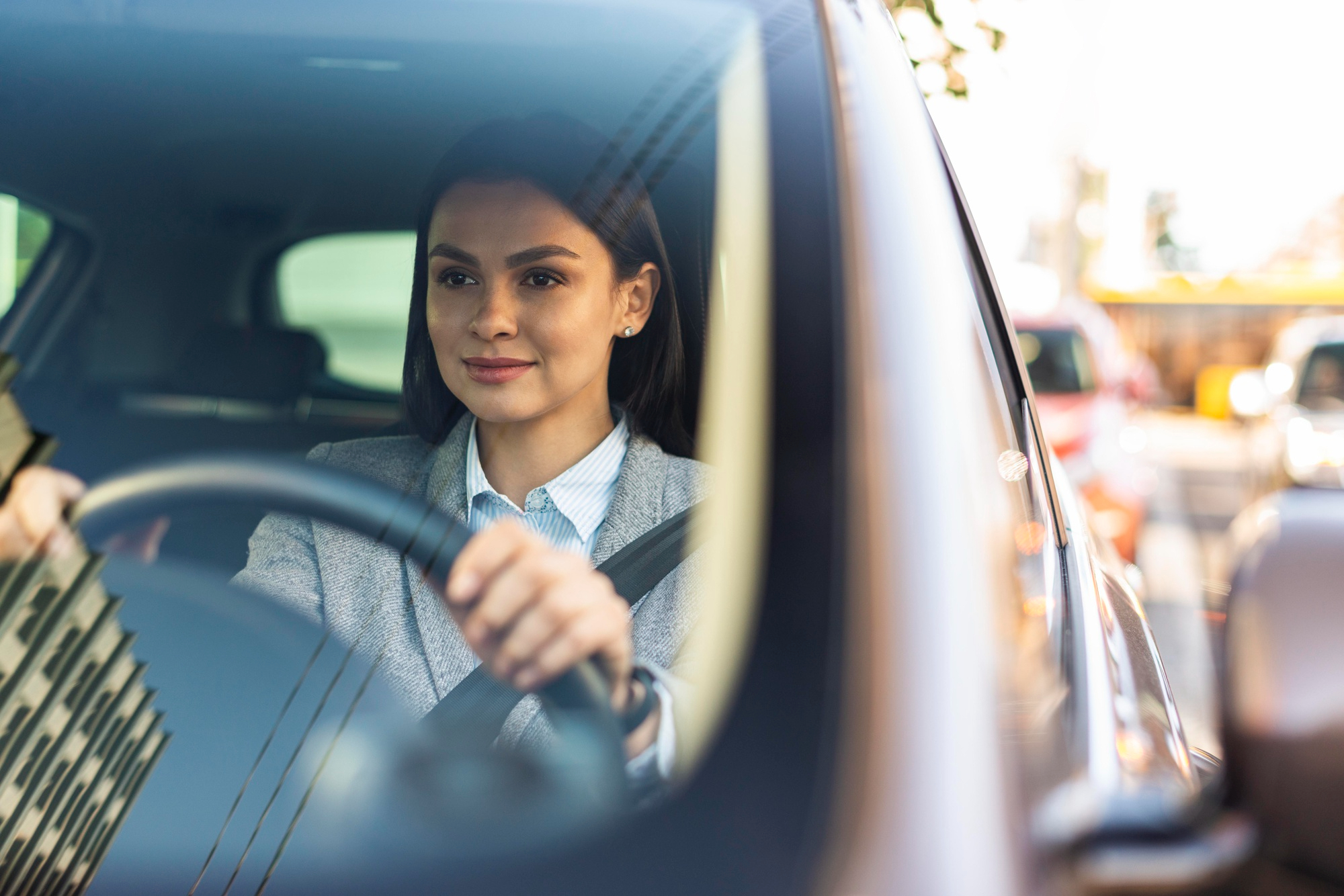 empresaria-sonriente-conduciendo-su-coche